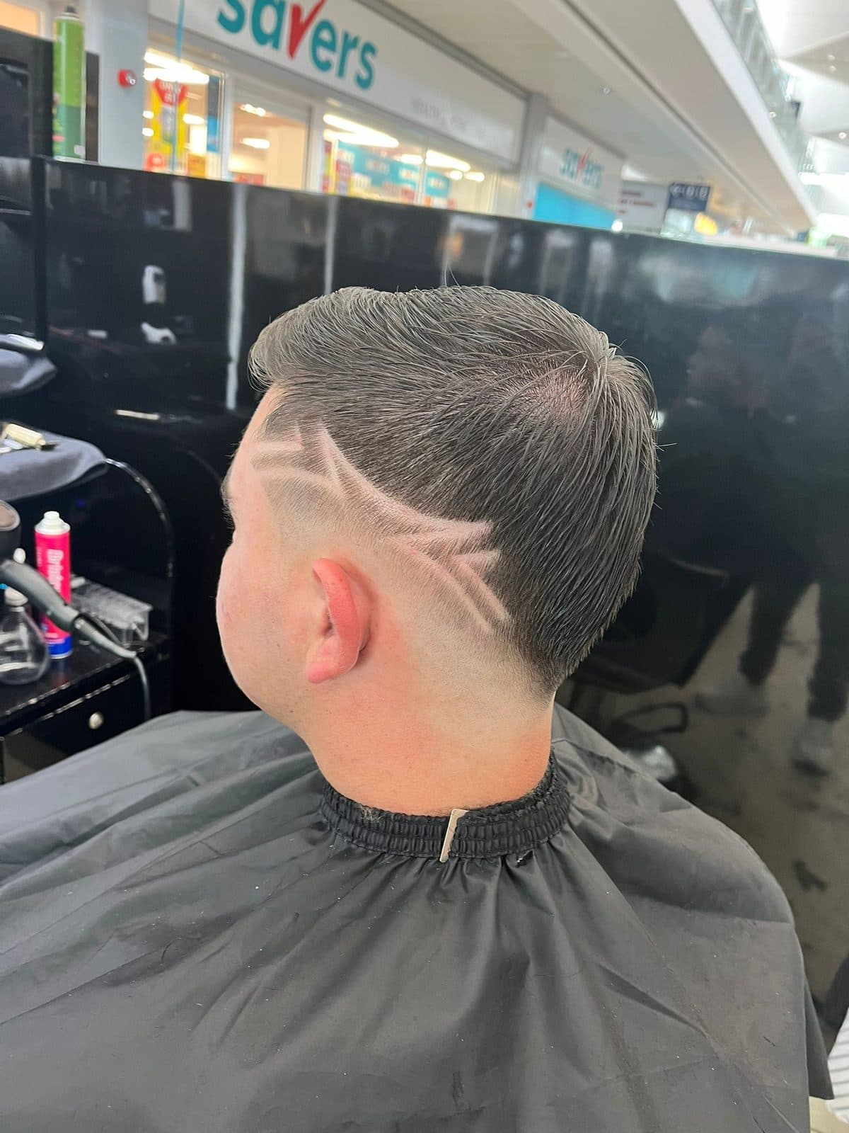 Scissor cut with textured top and a shaved side pattern