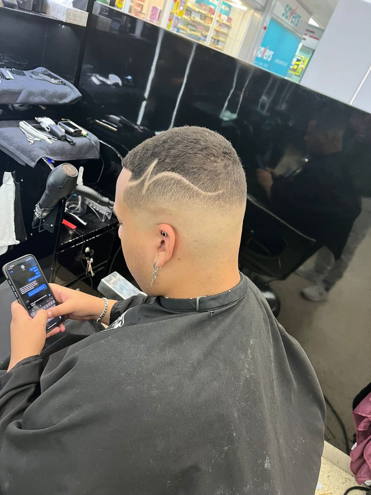 High skin fade with a curved design line