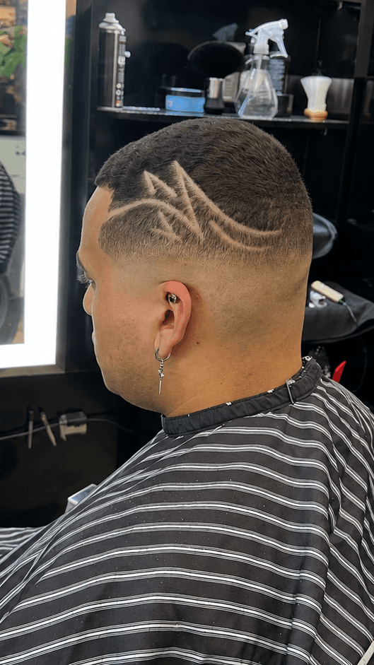A sharp skin fade with a freehand hair design, cut at Bradley Stoke Barbers